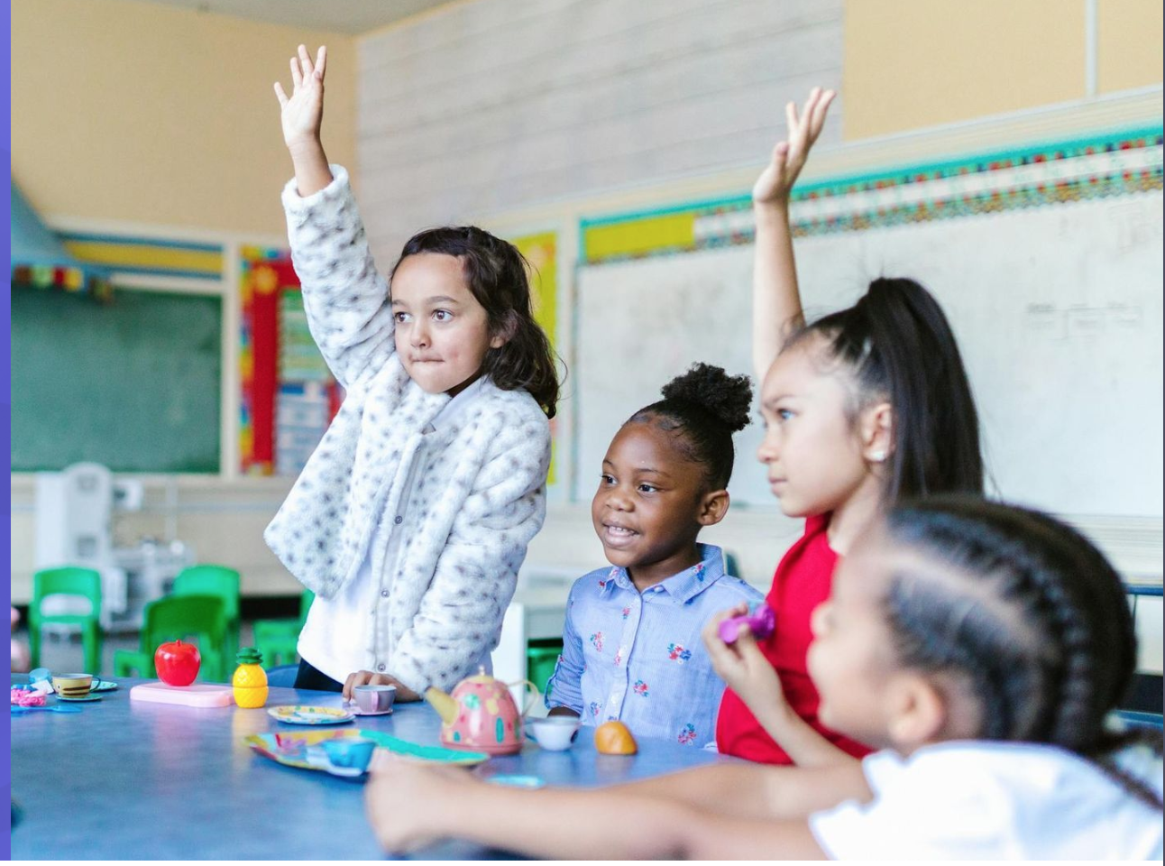 A diverse group of elementary students engaged in a communication activity around a classroom table